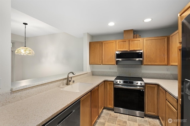 kitchen featuring stainless steel appliances, light countertops, and a sink