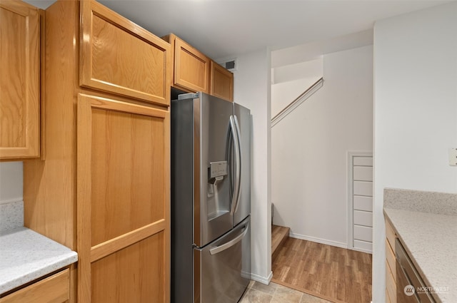 kitchen featuring light wood-style floors and stainless steel fridge