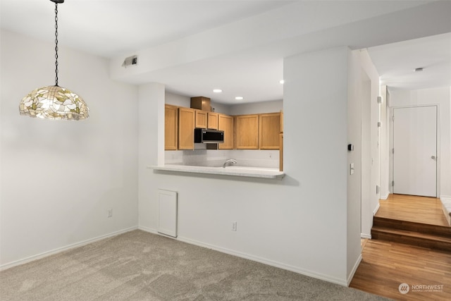 kitchen with recessed lighting, stainless steel microwave, baseboards, and light countertops