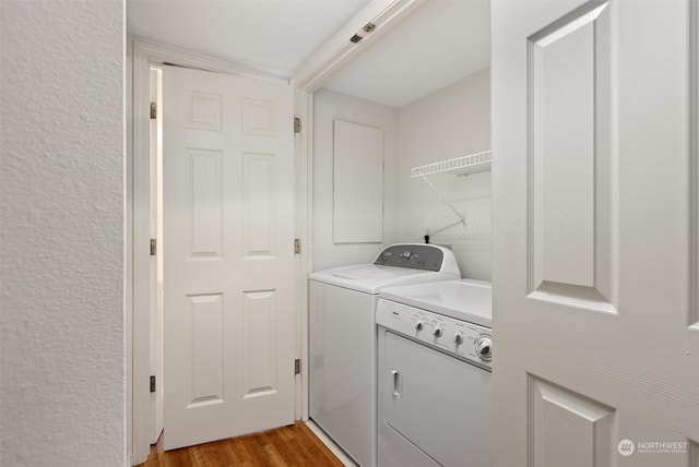 laundry area featuring laundry area, independent washer and dryer, and light wood-style floors