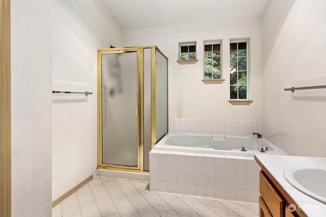 full bath featuring baseboards, a shower stall, vanity, and a garden tub