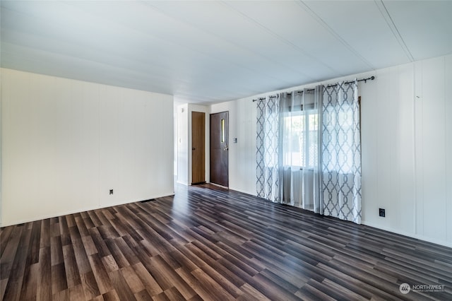 spare room with dark hardwood / wood-style floors