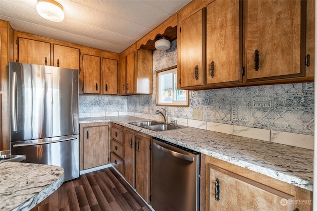 kitchen featuring dark wood-type flooring, decorative backsplash, appliances with stainless steel finishes, and sink