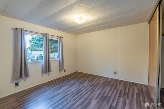 empty room featuring dark hardwood / wood-style floors