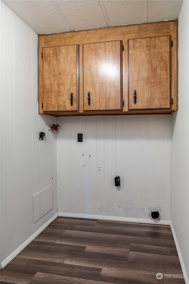 washroom featuring electric dryer hookup, washer hookup, dark hardwood / wood-style floors, and cabinets