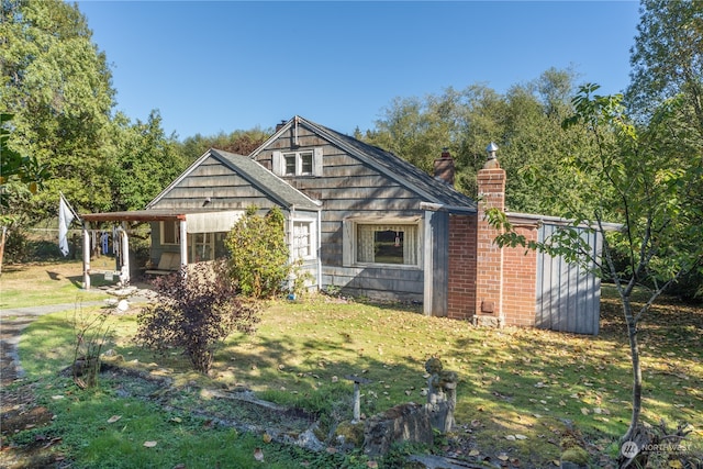 rear view of house with a yard