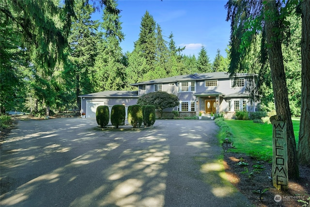 view of front of home with a front yard and a garage