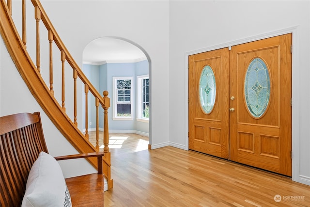 entrance foyer featuring light hardwood / wood-style flooring and ornamental molding