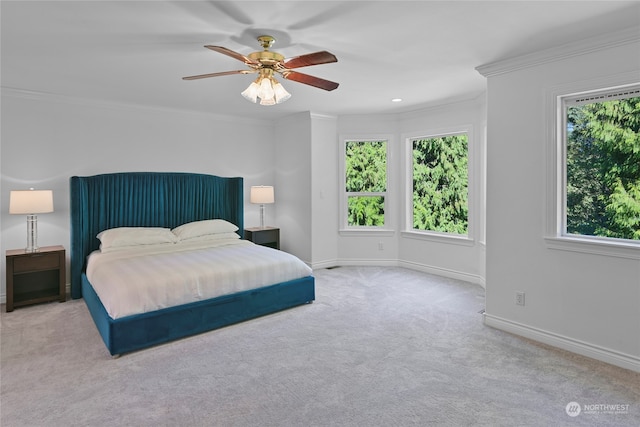 bedroom with crown molding, light carpet, and ceiling fan