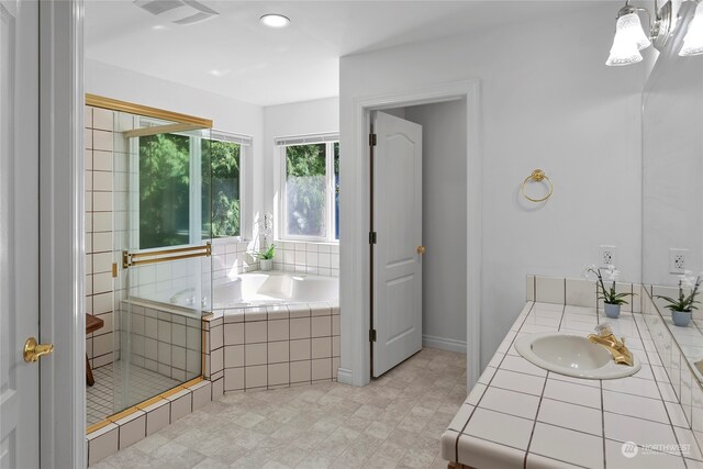 bathroom featuring independent shower and bath and vanity