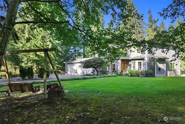 view of front of house featuring a garage and a front yard