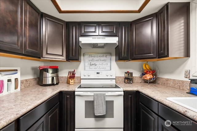 kitchen with white electric range oven and dark brown cabinetry