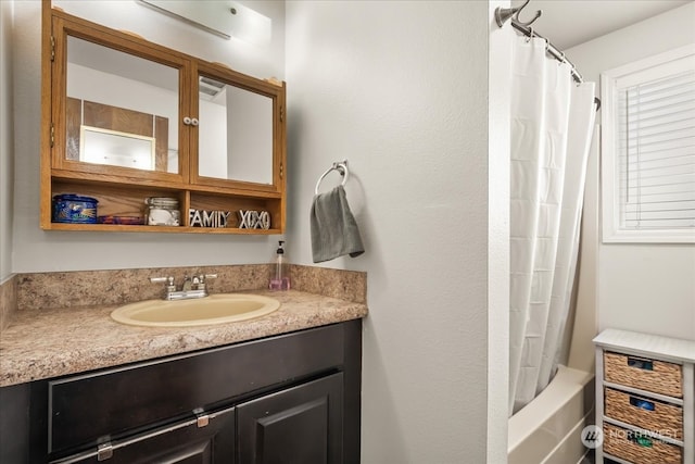 bathroom featuring vanity and shower / bathtub combination with curtain