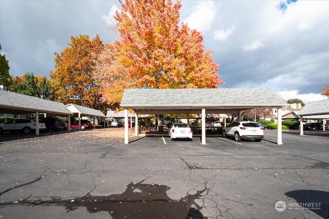 view of parking / parking lot featuring a carport