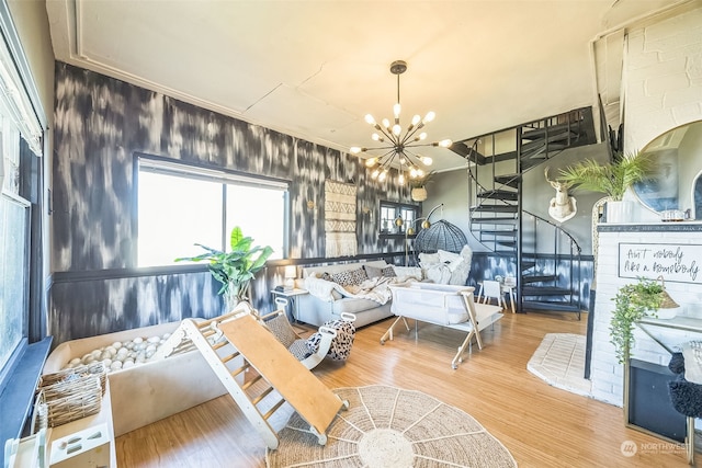 living room featuring wood-type flooring and an inviting chandelier