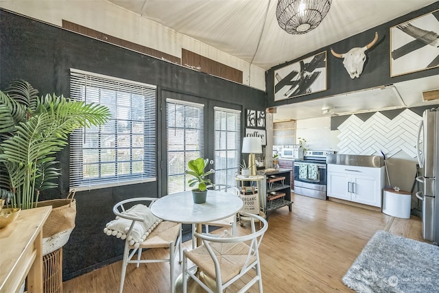 dining space with light wood-type flooring