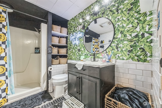 bathroom with vanity, tile walls, toilet, and a shower with shower curtain