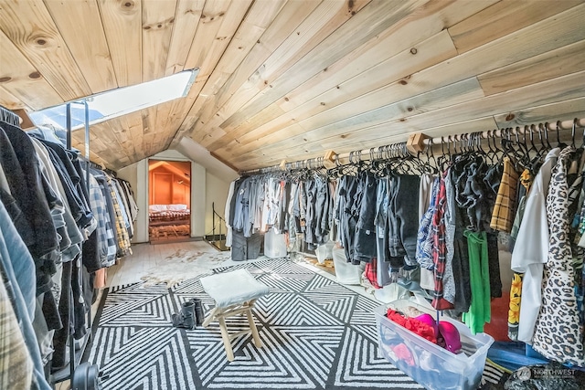 spacious closet featuring lofted ceiling with skylight and hardwood / wood-style flooring