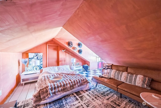 interior space featuring wood-type flooring and vaulted ceiling