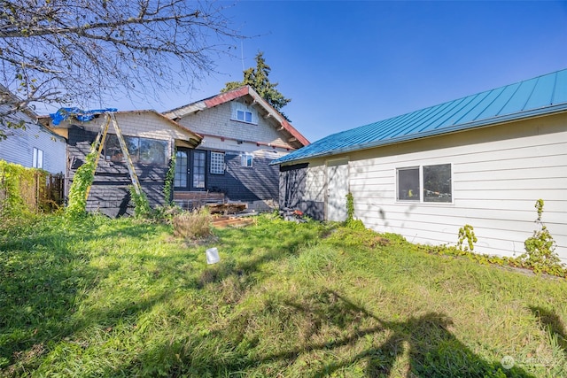 rear view of house with a yard