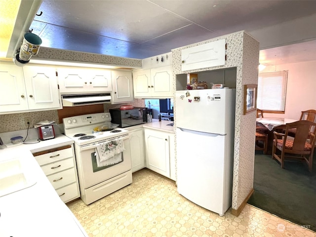 kitchen featuring white cabinets, white appliances, and extractor fan