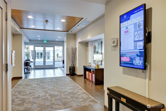 interior space featuring french doors, tile patterned flooring, and wooden ceiling