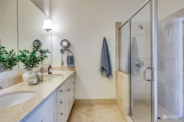 bathroom featuring a shower with shower door and vanity