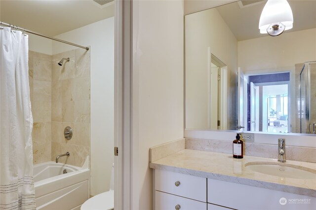 full bathroom featuring shower / bath combination with curtain, vanity, and toilet