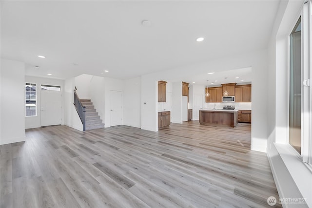 unfurnished living room featuring light wood-type flooring