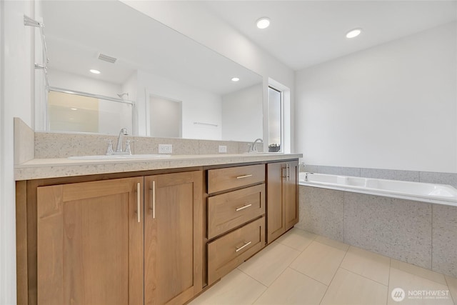 bathroom featuring vanity, shower with separate bathtub, and tile patterned flooring