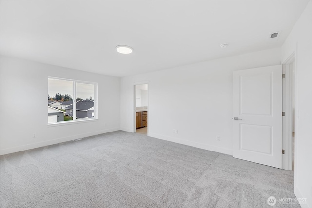 empty room featuring light colored carpet