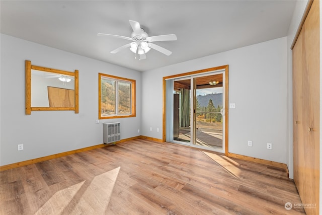 unfurnished room with ceiling fan and light wood-type flooring