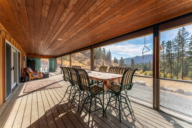 sunroom / solarium with a mountain view and wood ceiling