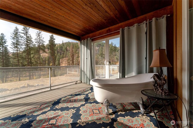 sunroom / solarium featuring wooden ceiling