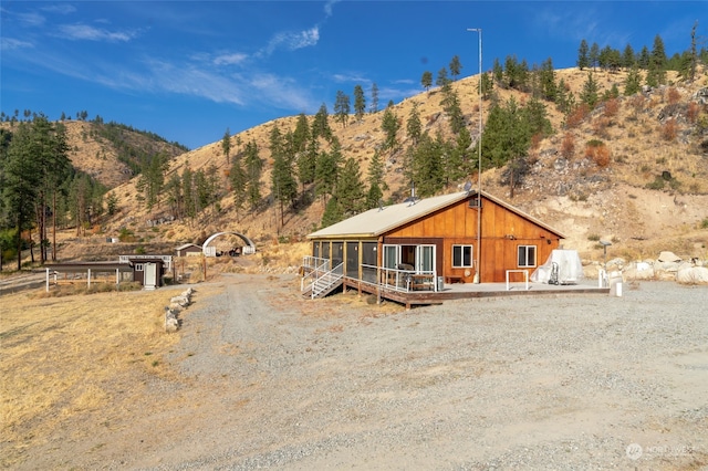 view of front of house featuring a deck with mountain view