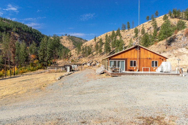 view of front of property featuring a deck with mountain view