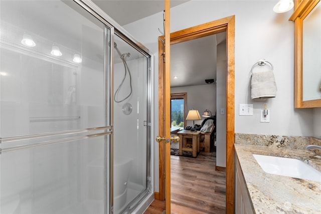 bathroom featuring an enclosed shower, hardwood / wood-style floors, and vanity