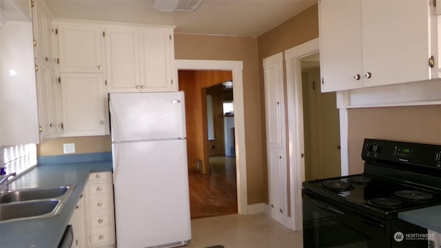 1555 Swartout Rd, Manson, WA 98831 - kitchen with freestanding refrigerator, electric range, white cabinetry, and a sink