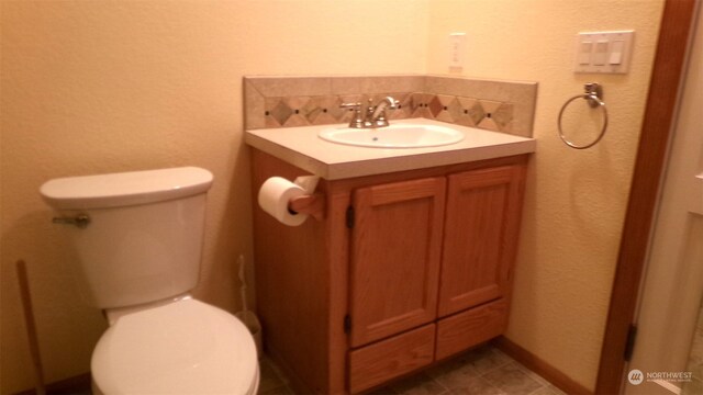 1555 Swartout Rd, Manson, WA 98831 - bathroom with vanity, toilet, and tasteful backsplash