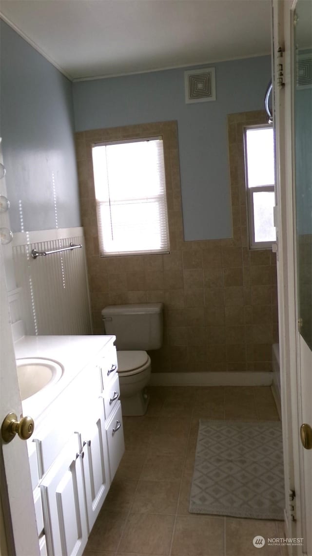 1555 Swartout Rd, Manson, WA 98831 - bathroom with tile walls, tile patterned floors, toilet, vanity, and a shower