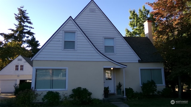 rear view of house with a garage