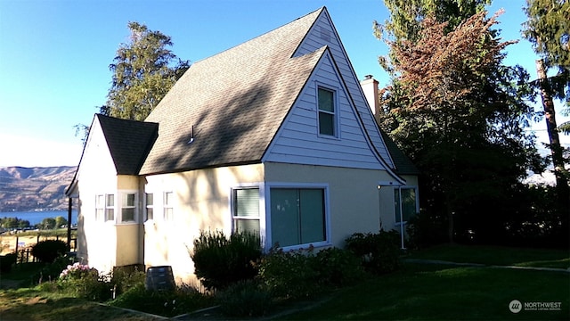 view of property exterior featuring a lawn