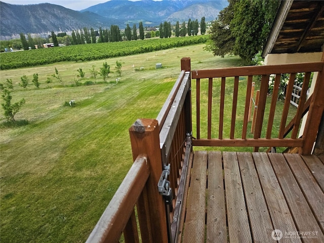 1555 Swartout Rd, Manson, WA 98831 - wooden terrace with a rural view, a mountain view, a lawn, and agricultural plots