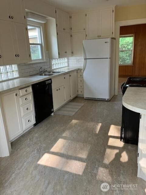 1555 Swartout Rd, Manson, WA 98831 - kitchen featuring freestanding refrigerator, dishwasher, backsplash, and white cabinetry