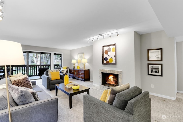 living room with light colored carpet and track lighting