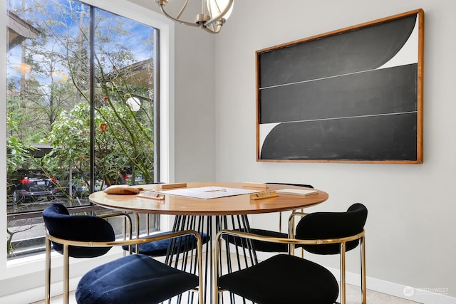 tiled dining room with an inviting chandelier