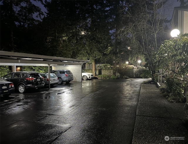 view of garage at twilight