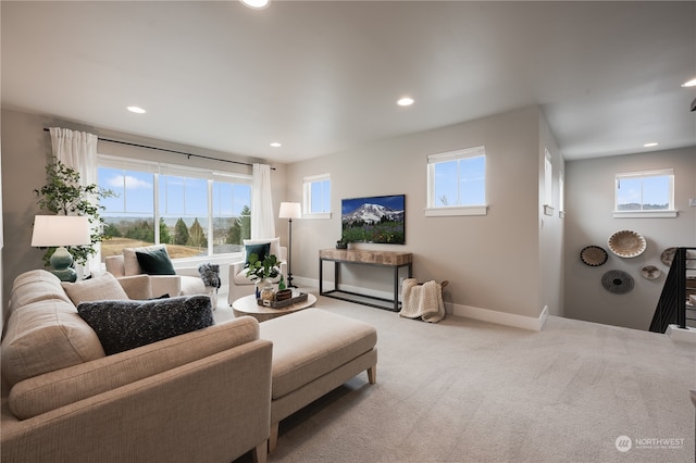 living room with a wealth of natural light and light carpet