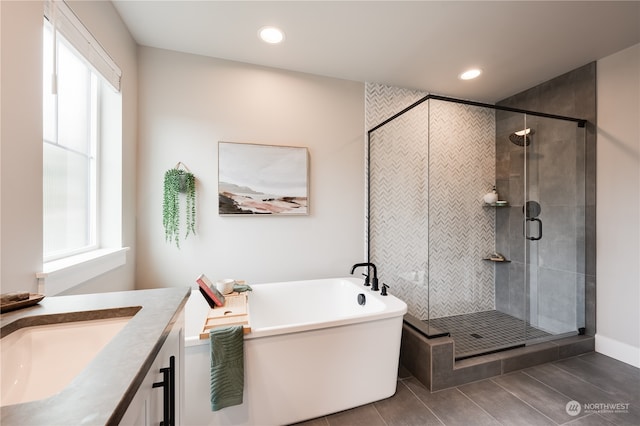 bathroom with vanity, plus walk in shower, and plenty of natural light