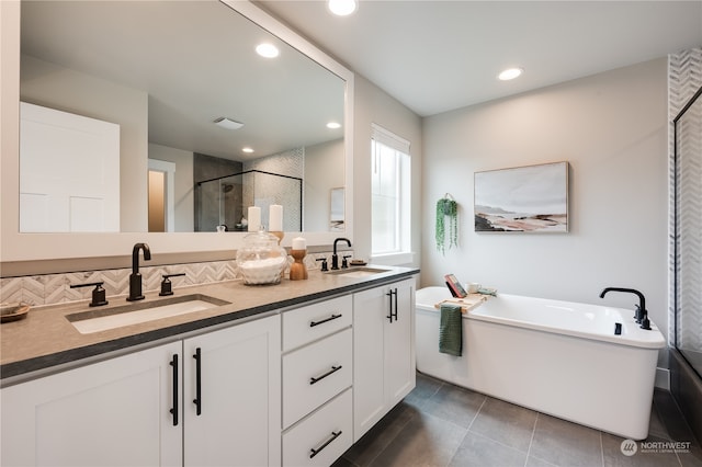 bathroom with tile patterned flooring, vanity, and independent shower and bath